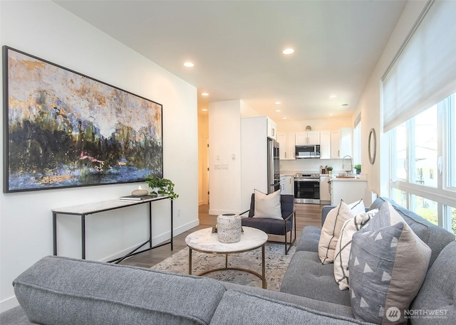 living area featuring recessed lighting, wood finished floors, and a wealth of natural light