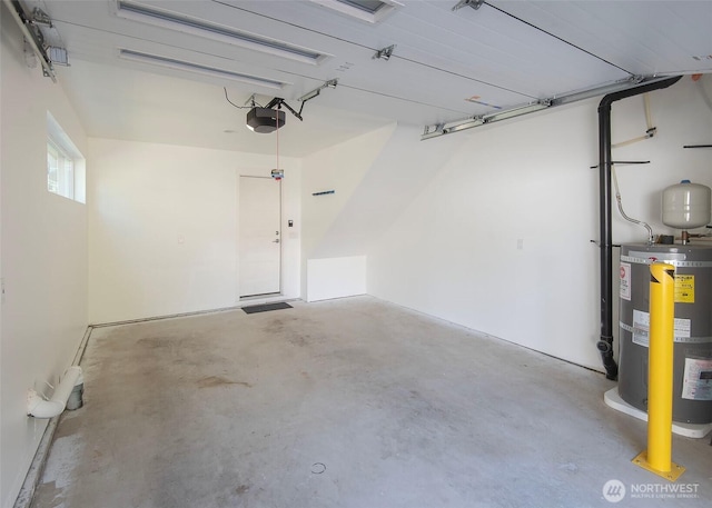 garage featuring strapped water heater and a garage door opener