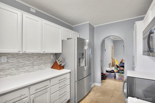 kitchen featuring tasteful backsplash, white cabinetry, light countertops, appliances with stainless steel finishes, and arched walkways