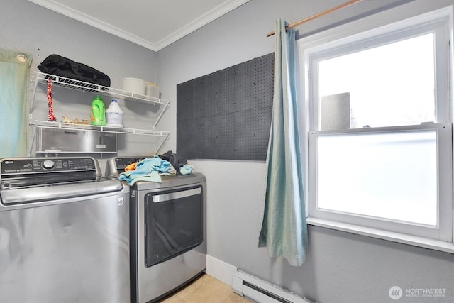 laundry area featuring a baseboard heating unit, tile patterned flooring, crown molding, independent washer and dryer, and laundry area
