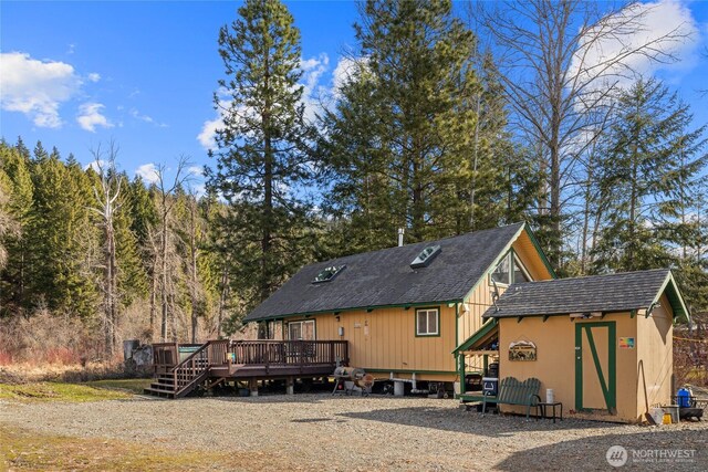 1081 Wapiti Dr, Cle Elum, WA 98922 - back of property with a deck, an outdoor structure, and roof with shingles
