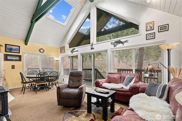 1081 Wapiti Dr, Cle Elum, WA 98922 - carpeted living area with high vaulted ceiling, baseboards, wood ceiling, beamed ceiling, and a skylight