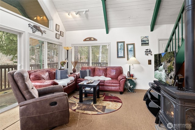 1081 Wapiti Dr, Cle Elum, WA 98922 - carpeted living area featuring a wood stove, plenty of natural light, and stairs