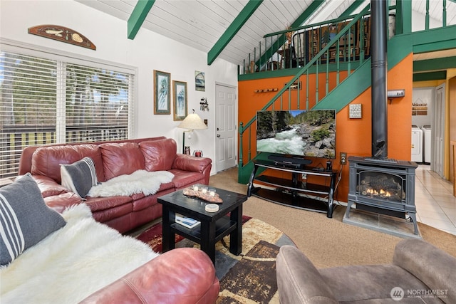 1081 Wapiti Dr, Cle Elum, WA 98922 - carpeted living area with washing machine and clothes dryer and a wood stove