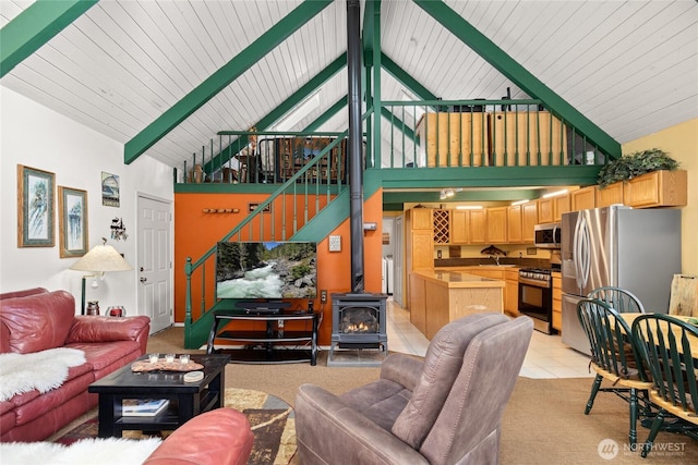 1081 Wapiti Dr, Cle Elum, WA 98922 - living room with high vaulted ceiling, a wood stove, beam ceiling, light tile patterned floors, and wooden ceiling