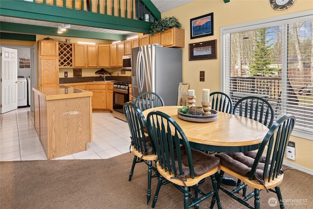 1081 Wapiti Dr, Cle Elum, WA 98922 - dining space featuring washer / clothes dryer, light tile patterned flooring, and lofted ceiling