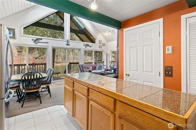1081 Wapiti Dr, Cle Elum, WA 98922 - kitchen with tile countertops, light tile patterned flooring, open floor plan, light carpet, and stainless steel fridge with ice dispenser
