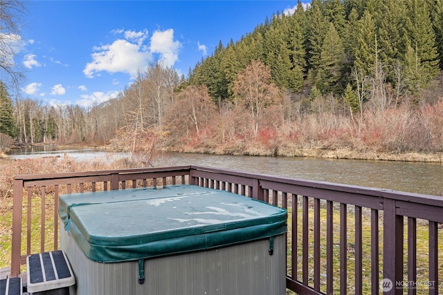 1081 Wapiti Dr, Cle Elum, WA 98922 - wooden terrace featuring a hot tub, a water view, and a forest view
