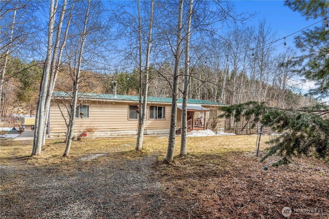 exterior space featuring metal roof and fence