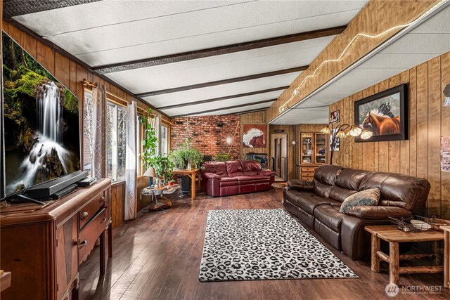 living room with beamed ceiling, dark wood-style floors, and wood walls