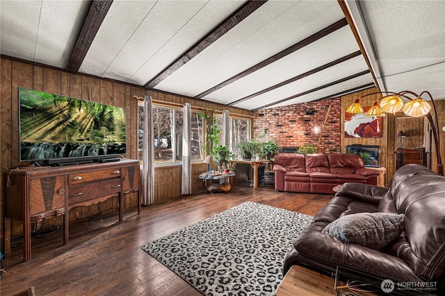 living room with hardwood / wood-style flooring, a textured ceiling, wood walls, a fireplace, and vaulted ceiling with beams