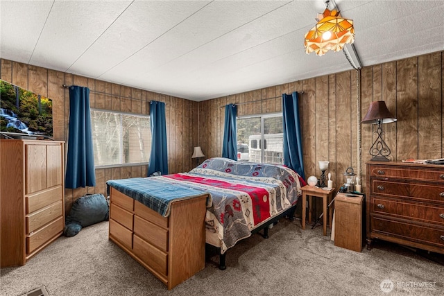 carpeted bedroom with wooden walls
