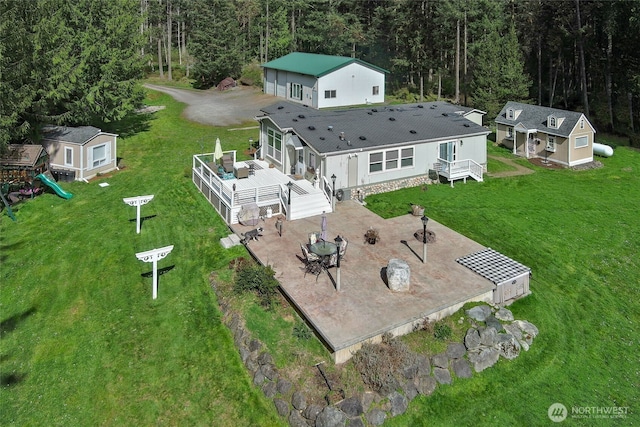 birds eye view of property featuring a view of trees