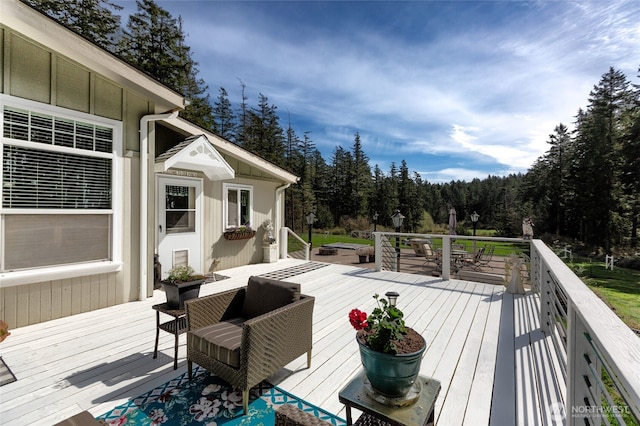 wooden deck featuring a view of trees