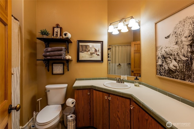 full bathroom with vanity and toilet