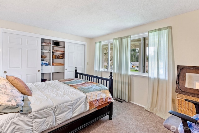 2913 SE Forest Villa Ct, Port Orchard, WA 98366 - bedroom with light carpet, a closet, and a textured ceiling