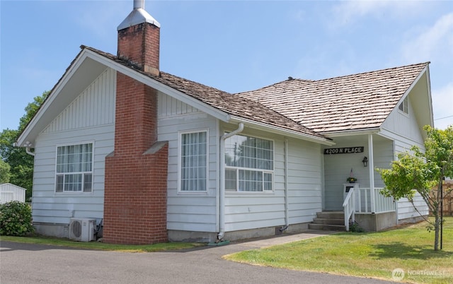 4200 N Pl, Seaview, WA 98644 - view of front facade featuring a chimney and a front lawn