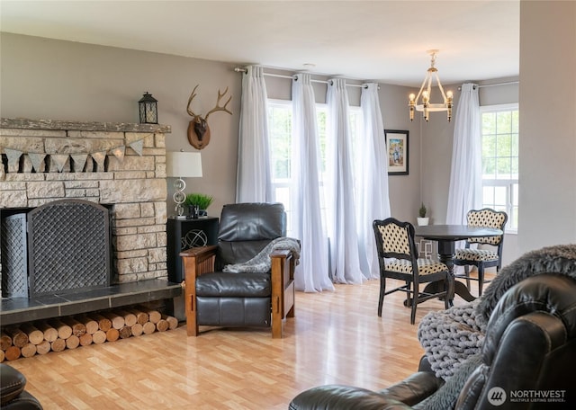 4200 N Pl, Seaview, WA 98644 - living room with a chandelier, a fireplace, and wood finished floors