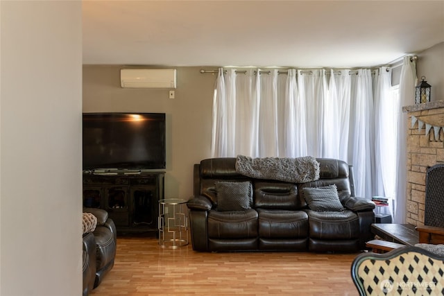 4200 N Pl, Seaview, WA 98644 - living area featuring plenty of natural light, a wall unit AC, wood finished floors, and a fireplace