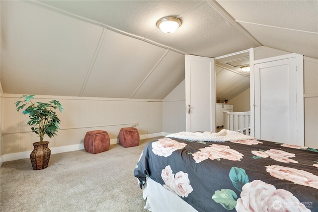 carpeted bedroom featuring baseboards and lofted ceiling
