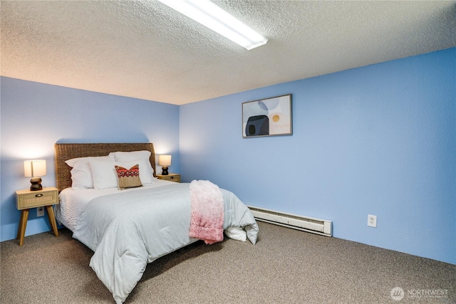 bedroom with carpet floors, a baseboard heating unit, and a textured ceiling