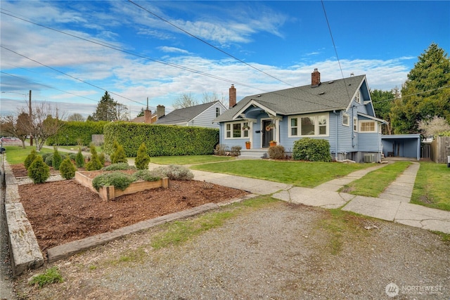 bungalow-style house featuring driveway, a front yard, a chimney, fence, and a garden