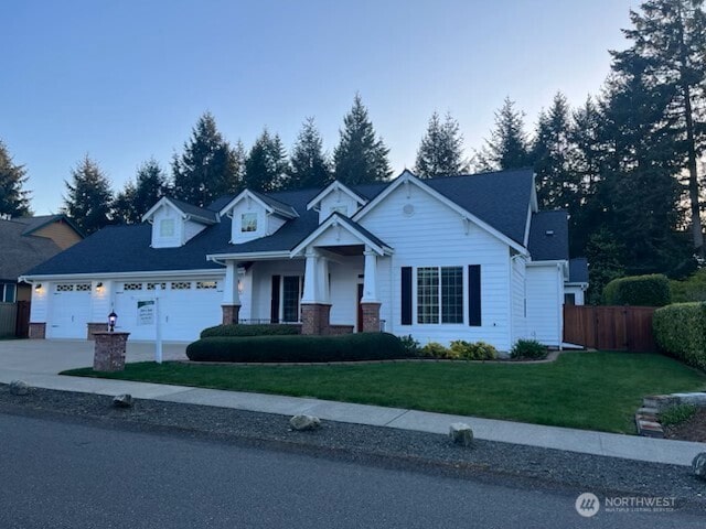 703 Torden Ln SE, Olympia, WA 98513 - view of front facade featuring concrete driveway, fence, a front yard, and a garage