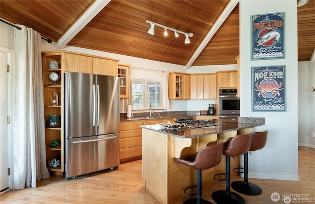 6926 Holeman Ave, Blaine, WA 98230 - kitchen with light brown cabinets, glass insert cabinets, light wood-style flooring, appliances with stainless steel finishes, and wooden ceiling