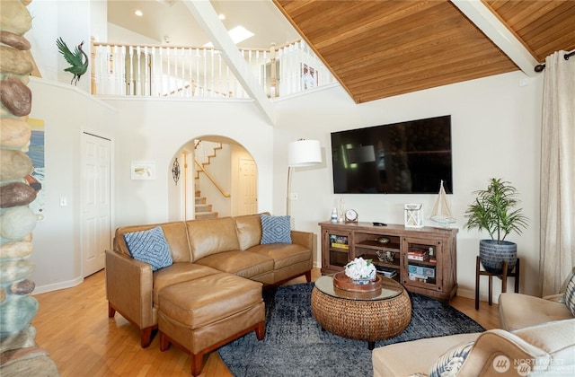 6926 Holeman Ave, Blaine, WA 98230 - living room with beam ceiling, stairway, arched walkways, and light wood-type flooring
