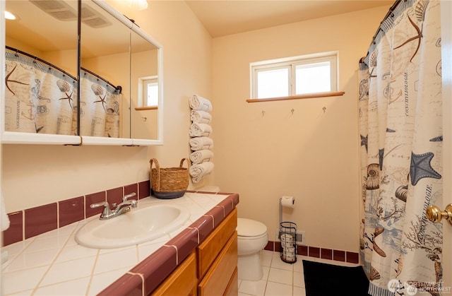 6926 Holeman Ave, Blaine, WA 98230 - full bath featuring vanity, tile patterned floors, toilet, and a shower with shower curtain