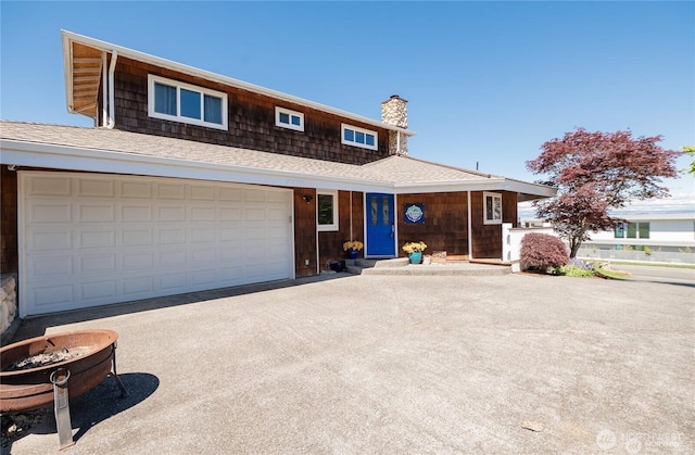 6926 Holeman Ave, Blaine, WA 98230 - view of front of home featuring an attached garage, a chimney, and a shingled roof