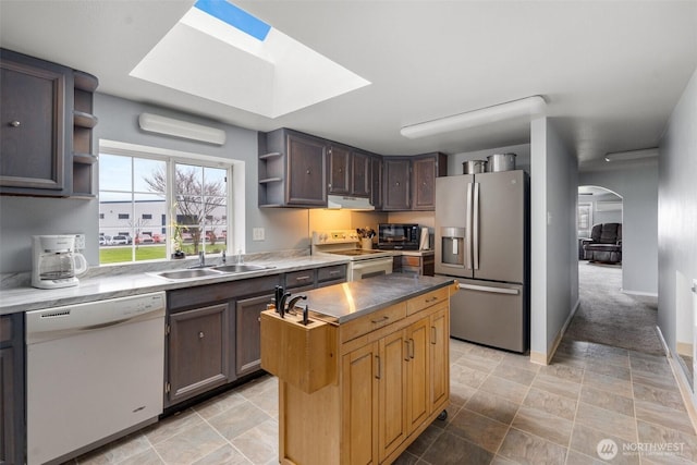 139 N Star Dr, Chehalis, WA 98532 - kitchen with a skylight, white appliances, a kitchen island, a sink, and open shelves