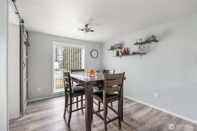 139 N Star Dr, Chehalis, WA 98532 - dining room with baseboards, a barn door, and light wood finished floors