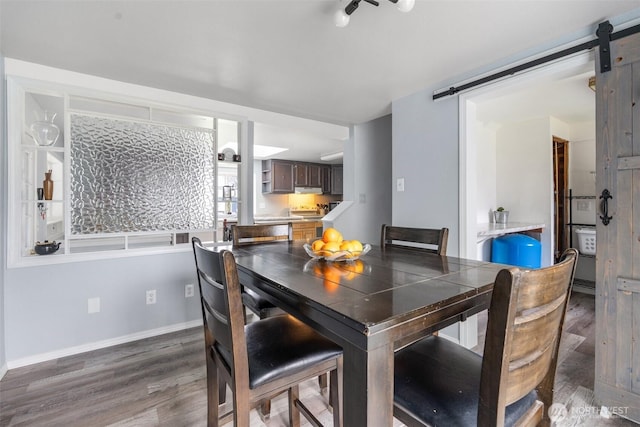 139 N Star Dr, Chehalis, WA 98532 - dining room featuring baseboards, a barn door, and wood finished floors