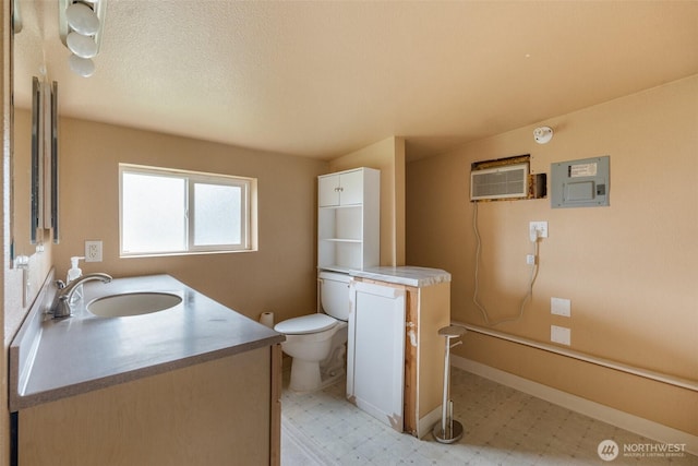 139 N Star Dr, Chehalis, WA 98532 - bathroom with tile patterned floors, toilet, vanity, a wall unit AC, and baseboards