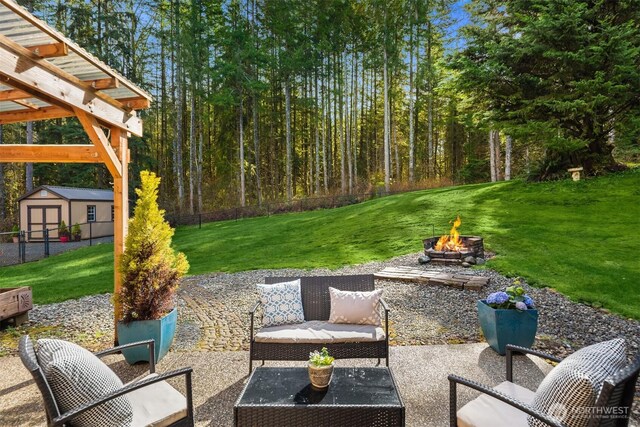 4111 161st Ave NE, Snohomish, WA 98290 - view of patio / terrace with an outdoor structure, an outdoor living space with a fire pit, and a storage unit