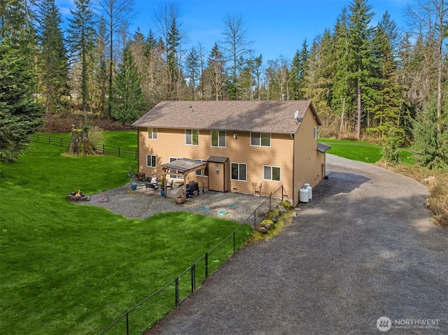 4111 161st Ave NE, Snohomish, WA 98290 - rear view of house with fence, gravel driveway, a yard, and a patio area