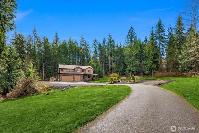 4111 161st Ave NE, Snohomish, WA 98290 - surrounding community with a lawn, driveway, a garage, and a wooded view