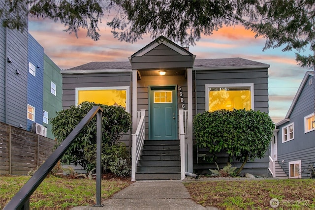 exterior entry at dusk featuring fence