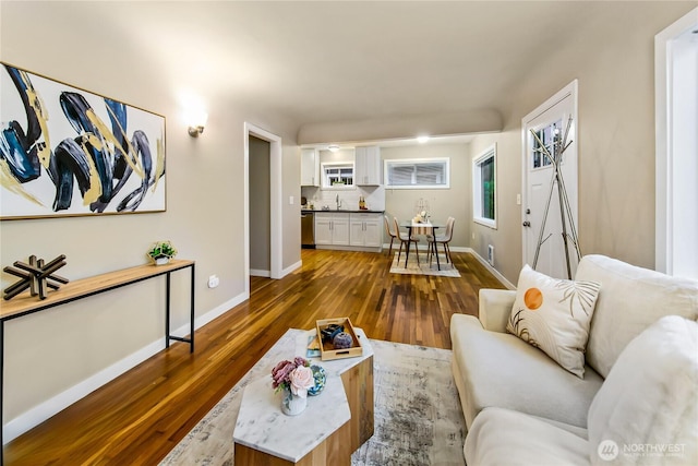 living room with baseboards and dark wood-style flooring