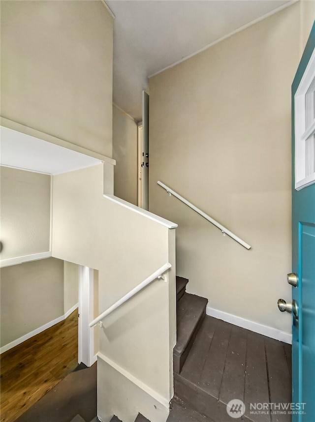 stairs with baseboards and wood-type flooring