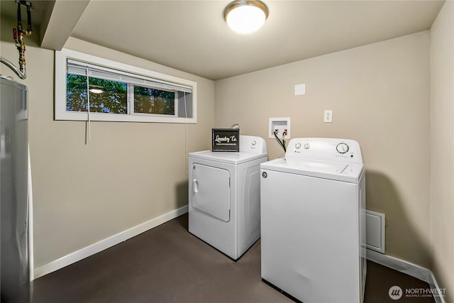 laundry area with laundry area, baseboards, and washer and clothes dryer