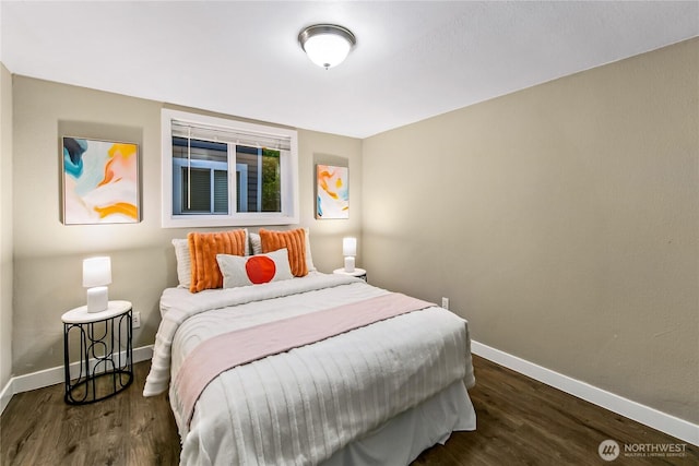 bedroom with baseboards and dark wood-style flooring