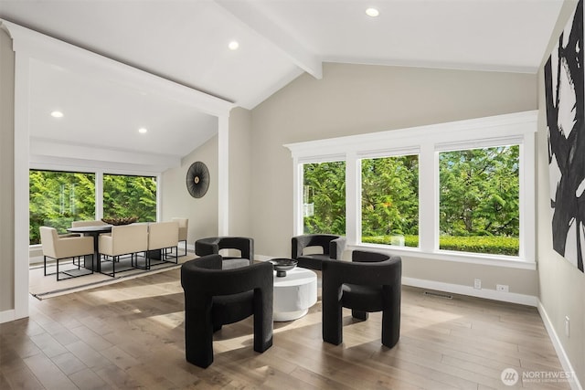 interior space with lofted ceiling with beams, visible vents, recessed lighting, hardwood / wood-style floors, and baseboards