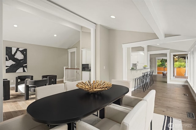 dining space with wood finished floors, vaulted ceiling with beams, visible vents, and recessed lighting