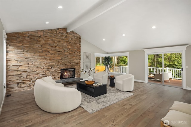 living area with high vaulted ceiling, a fireplace, beam ceiling, and wood finished floors