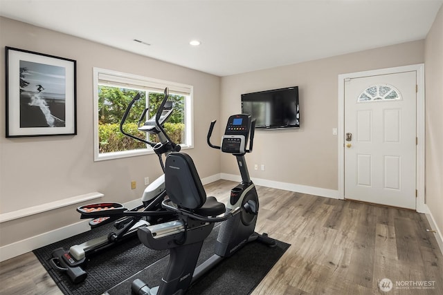 exercise room with recessed lighting, baseboards, and wood finished floors