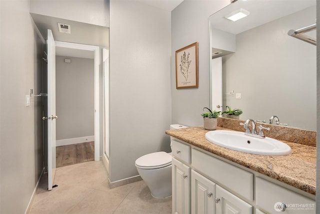 full bathroom with toilet, tile patterned floors, vanity, and baseboards