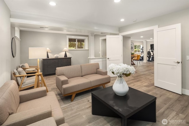 living room with visible vents, light wood-style flooring, recessed lighting, and plenty of natural light