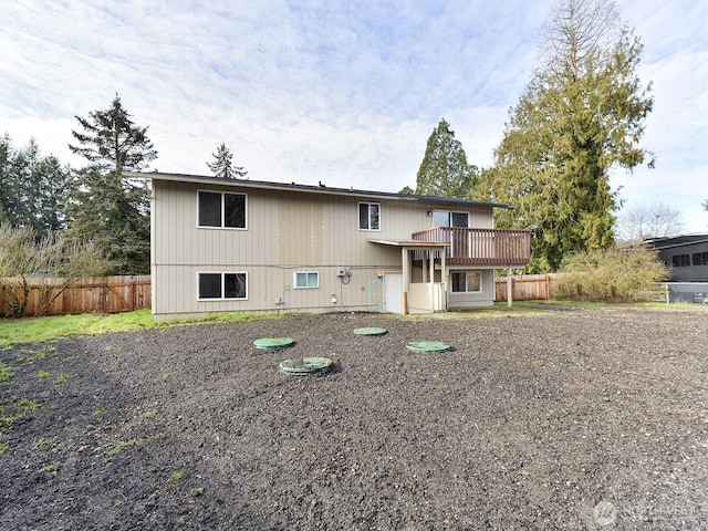 back of property featuring fence